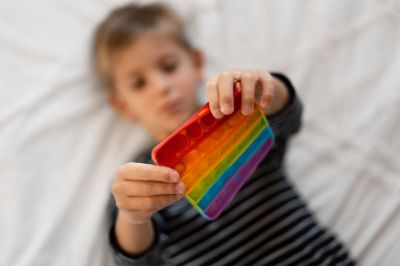 close-up-child-playing-with-pop-it-toy